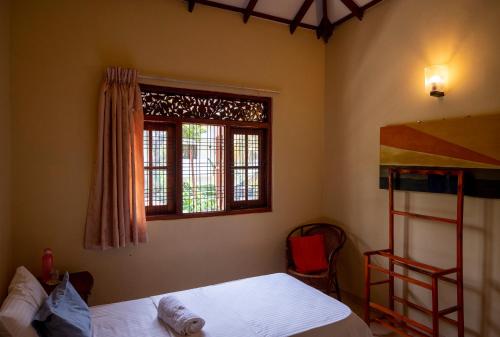 a bedroom with a bunk bed and a window at The Tourist Balcony in Negombo
