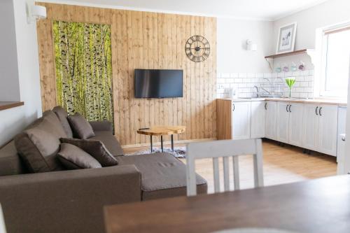 a living room with a couch and a table at Apartamenty Przylesie in Polanica-Zdrój