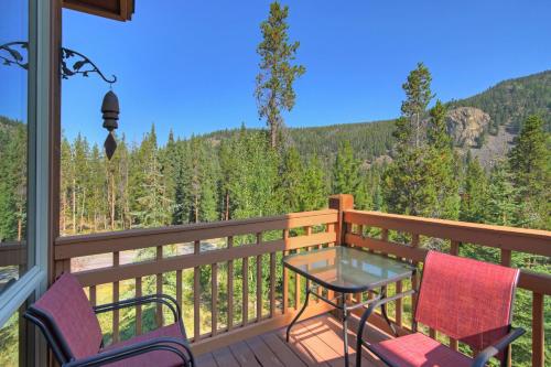 a balcony with a table and chairs and a view of the mountains at East Keystone by Vail Resorts in Keystone