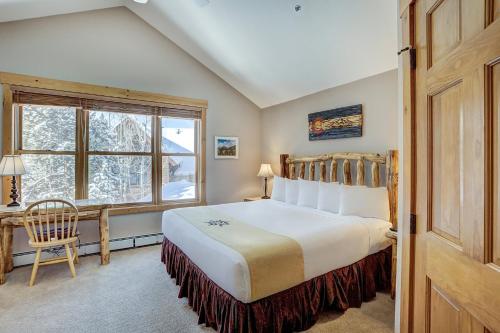 a bedroom with a large bed and a window at East Keystone by Vail Resorts in Keystone
