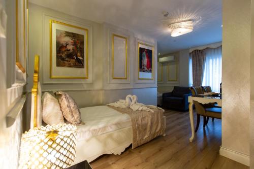 Sirkeci Ersu Hotel & SPA في إسطنبول: غرفة نوم مع سرير وغرفة معيشة