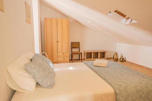 a bedroom with a large white bed in a room at Colors Pool House in Carvoeiro