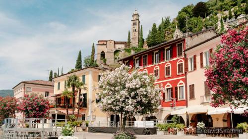 a group of buildings in a town with flowers at Casa Angiolina - Holidays in Morcote