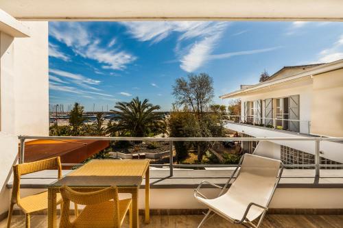 a view from the balcony of a house with a table and chairs at Hotel Residence Hibiscus in La Caletta
