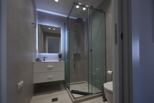 a bathroom with a glass shower and a toilet at Corfu Venetian Luxury Apartment in Corfu Town