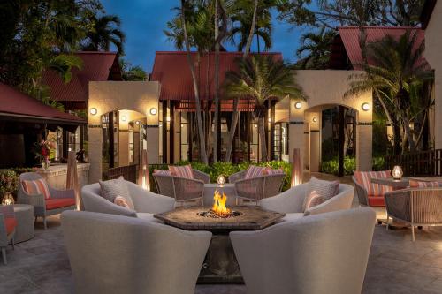 a patio with chairs and a fire pit in front of a building at Carambola Beach Resort St. Croix, US Virgin Islands in North Star