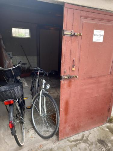 a bike parked next to a red door at Ossola Bella la tua casa in Domodossola