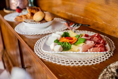 a table with three plates of food on it at FORESTERIA di PALAZZO RADICI in Bergamo