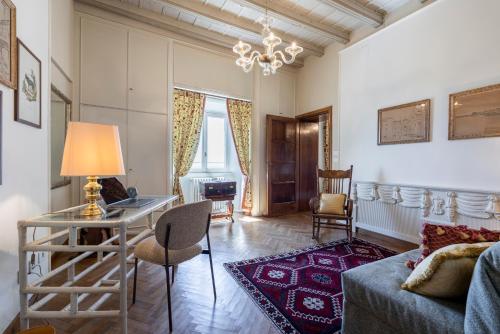 a living room with a couch and a table at FORESTERIA di PALAZZO RADICI in Bergamo