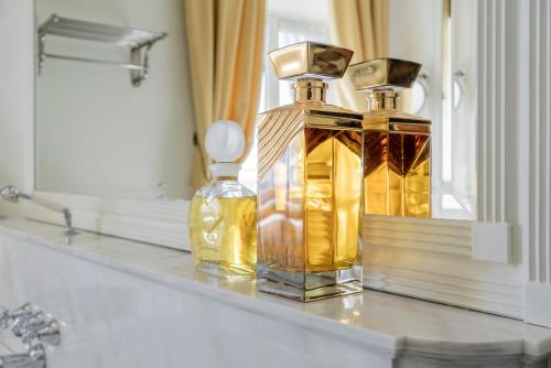 two bottles of perfume sitting on a bathroom counter at FORESTERIA di PALAZZO RADICI in Bergamo