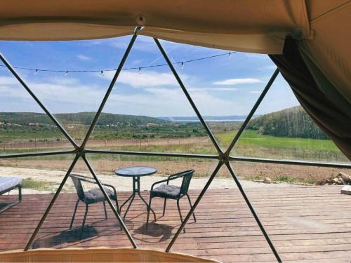 - une vue depuis une tente avec des chaises et une table dans l'établissement Baladome, à Dörgicse
