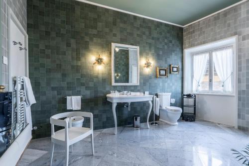 a bathroom with a sink and a toilet at FORESTERIA di PALAZZO RADICI in Bergamo