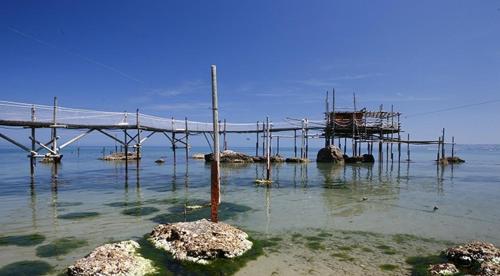 a wooden dock in the water with a pier at B&B Villa Angela in San Salvo