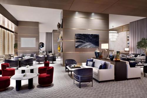 a hotel lobby with couches and tables and chairs at Suitestay Address Dubai Mall Residence in Dubai