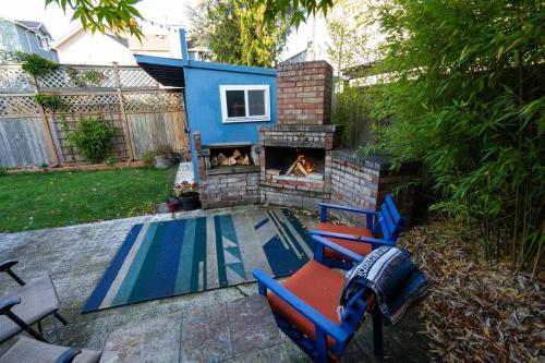a backyard with a fireplace and chairs and a fire place at Greenwood Mother in Law in Seattle