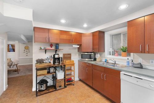 a kitchen with wooden cabinets and a counter top at Greenwood Mother in Law in Seattle