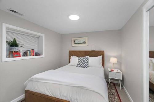 a white bedroom with a bed and a window at Greenwood Mother in Law in Seattle