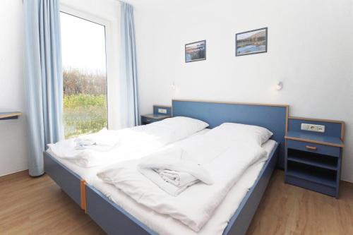 キュールングスボルンにあるYachthafenresidenz-Wohnung-8110-848の大きな窓付きの客室のベッド1台分です。