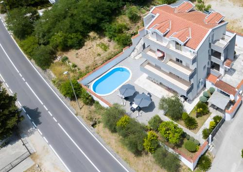an aerial view of a house with a swimming pool at Gemma di Cattaro Apartments in Kotor