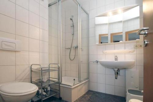a bathroom with a shower and a toilet and a sink at Yachthafenresidenz-Wohnung-8301-856 in Kühlungsborn