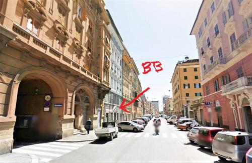 a city street with cars parked on the street at Stanza d'artista in Genova