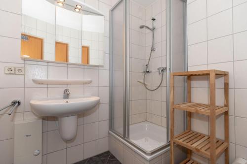a bathroom with a sink and a shower at Yachthafenresidenz-Wohnung-8210-876 in Kühlungsborn