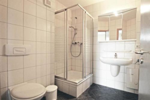 a bathroom with a shower and a toilet and a sink at Yachthafenresidenz-Wohnung-8201-873 in Kühlungsborn