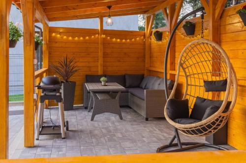a patio with a couch and a chair at Villa Sol in Oświęcim