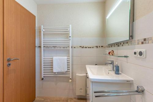 a bathroom with a sink and a mirror at Yachthafenresidenz-Wohnung-9101-877 in Kühlungsborn