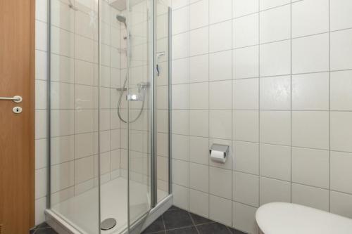 a bathroom with a shower and a toilet at Yachthafenresidenz-Wohnung-9105-905 in Kühlungsborn