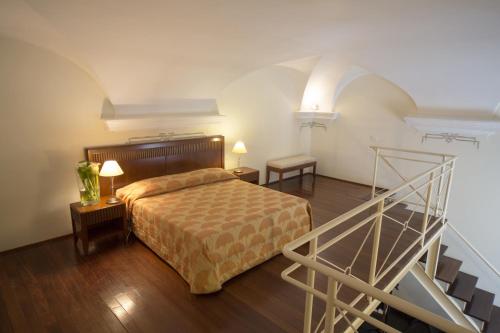 a bedroom with a bed and a staircase in a room at Villa Imperiale Hotel in Spotorno