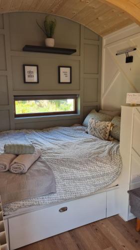 a bed in the middle of a tiny house at LittleGreenGlamping in Leitrim