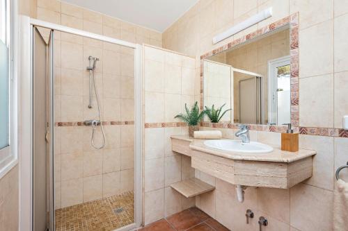 a bathroom with a sink and a shower at Villa Olives by Villa Plus in Ferreries