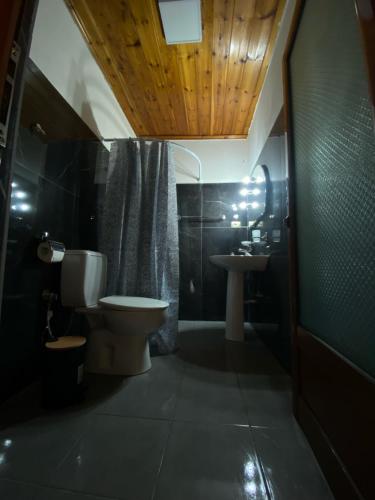 a bathroom with a toilet and a sink at Marko's House in Gjirokastër