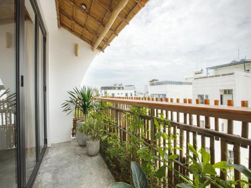 a balcony with plants and a view of the city at TA Danang Boutique Hotel in Da Nang