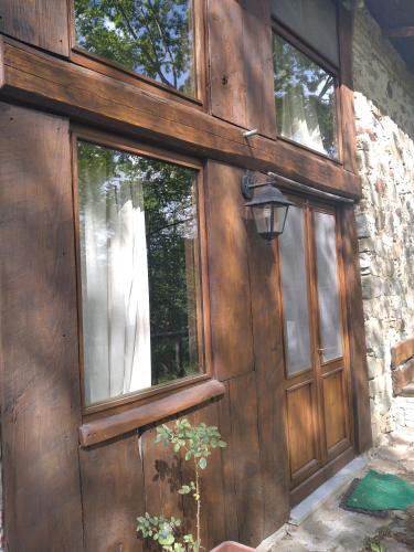 a wooden door with windows on a house at Villa Belvedere in Pieve Fosciana