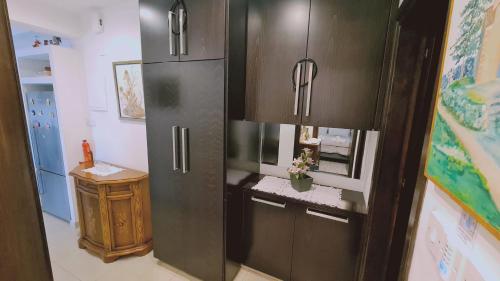 a kitchen with a black refrigerator in a room at STAY Serenity Apartment in Yukarı Lakatamya