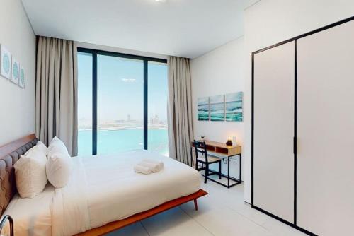 a bedroom with a bed and a view of the water at Address Beach Residence, JBR - Vacationer in Dubai