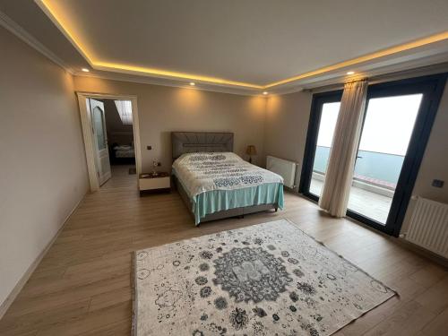 - une chambre avec un lit et une grande fenêtre dans l'établissement Villa Nature, à Trabzon