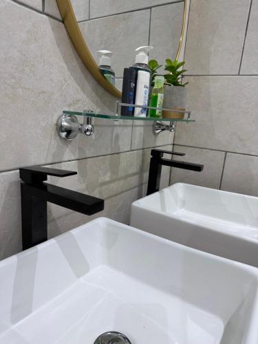 a bathroom with a white sink and a mirror at Private home in Douala