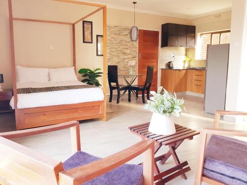 1 dormitorio con 1 cama y sala de estar en Chinyonga Guesthouse, en Limbe