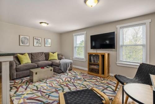 a living room with a couch and a flat screen tv at The Brew House - 2nd Floor Private Apartment in Portland