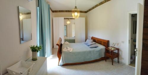 a bedroom with a bed with blue pillows on it at Agriturismo l' Annunziata in Lizzano