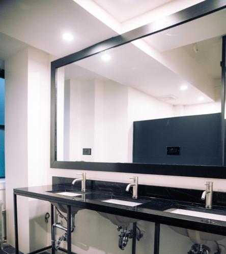 a bathroom with two sinks and a large mirror at KAMA CENTRAL PARK in New York