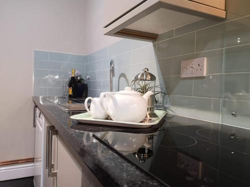 a kitchen counter with a tea pot on a plate at Biskey Bowness in Bowness-on-Windermere