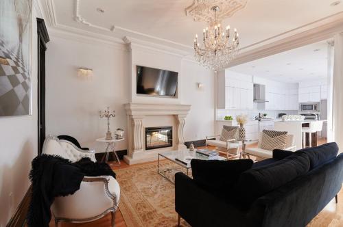 a living room with a couch and a fireplace at Villa Dante By Denstays in Montréal