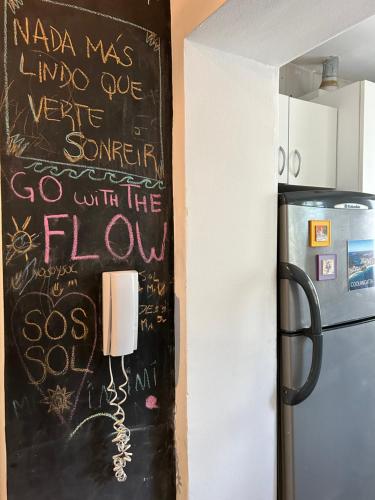 a chalkboard wall in a kitchen next to a refrigerator at Sol Palermo, Amplio departamento con terraza en zona La Rural, Embajada y Bosques in Buenos Aires