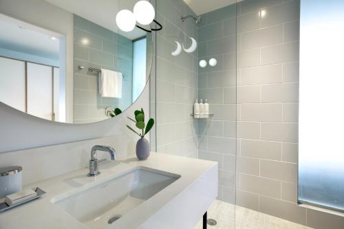 a bathroom with a sink and a mirror at Kimpton - Hotel Palomar South Beach, an IHG Hotel in Miami Beach