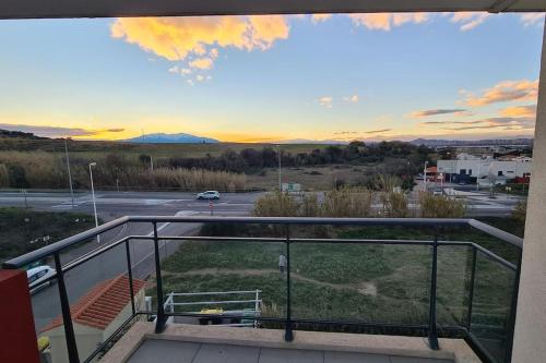 a balcony with a view of a parking lot at 302 Studio Cosy sur Perpignan in Perpignan