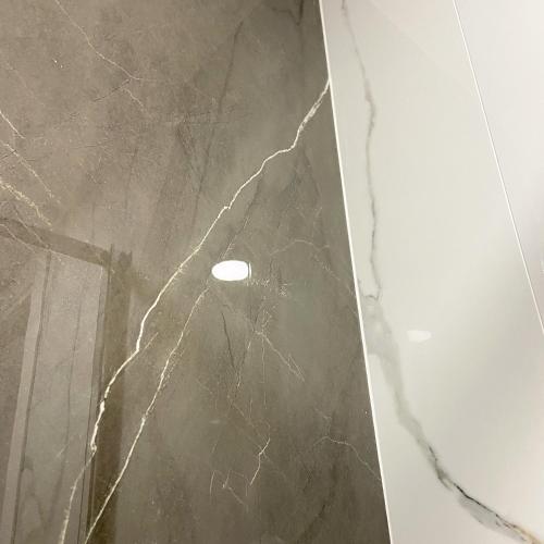 a close up of a marble wall with a light on it at GUALTIERI LUXURY SUITE in San Giorgio a Cremano